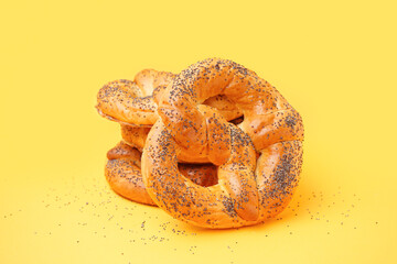 Stack of tasty pretzels on yellow background