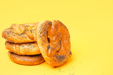 Stack of tasty pretzels on yellow background