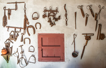 Old farm tools hanging on a wall