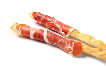 Tasty Italian Grissini with bacon on white background, closeup