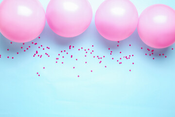 Fototapeta na wymiar Pink balloons and serpentine on blue background