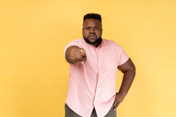 Man noticing and pointing finger to camera, accusing with serious bossy face, making choice.