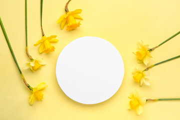 Beautiful narcissus and round blank card on color background