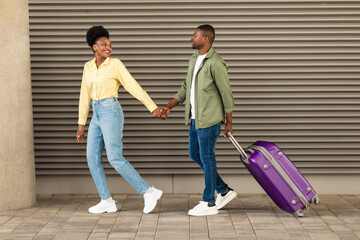 Full Length Shot Of Black Spouses Walking With Suitcase Outside