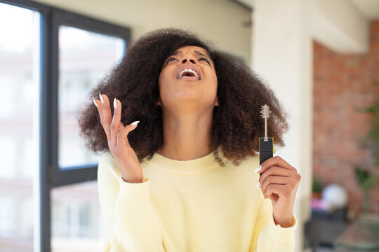 Pretty Afro Black Woman Screaming With Hands Up In The Air. New Home Key Concept