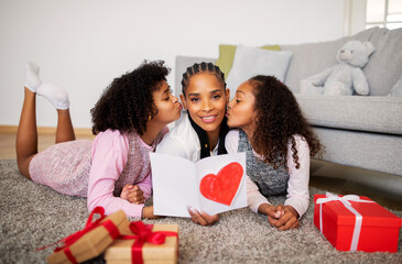 African Girls Kissing Mom Congratulating Her On Mother's Day Indoor