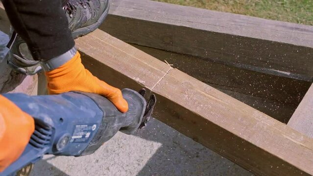 Slow-motion footage of a log being cut with a reciprocating Saw