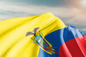 Ecuador national flag cloth fabric waving on beautiful grey sky.