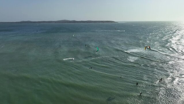 Aerial view of paragliders sailing on the ocean in sunny Cartagena, Colombia
