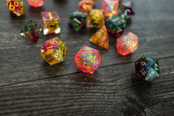 Colorful resin dice on dark hardwood