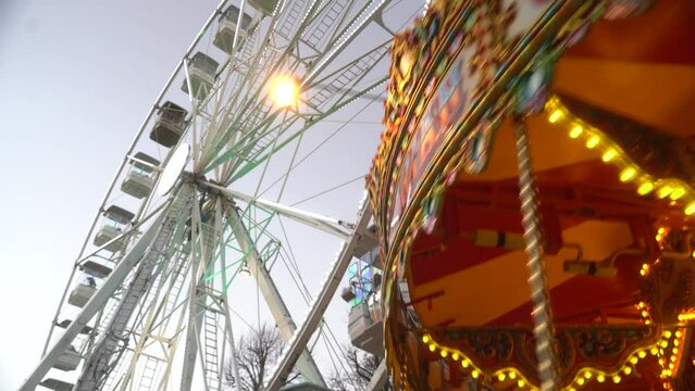 Carousel is spinning in front of the Ferris wheel. Kilkenny. ireland. 2023