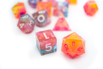 Multicolored resin dice scattered across a white surface