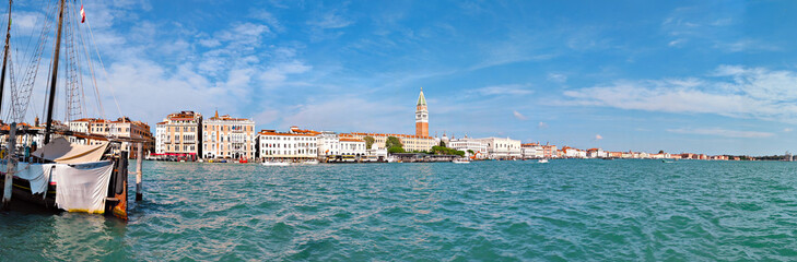 Obraz premium Panoramic view of central Venice from across the sea. This travel banner panorama features the stunning water in front of this Italian city.