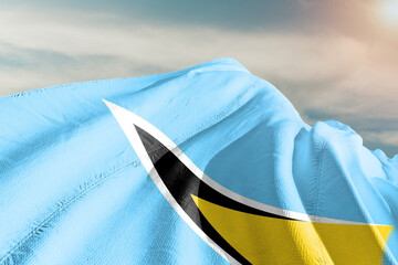 Saint Lucia national flag cloth fabric waving on beautiful grey sky.