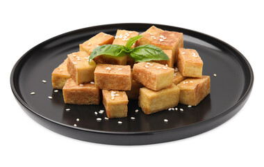 Plate with delicious fried tofu, basil and sesame seeds on white background