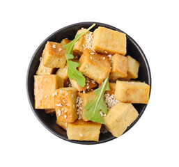 Delicious fried tofu, basil and sesame seeds in bowl isolated on white, top view