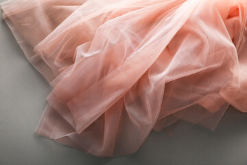 Beautiful tulle fabric on grey background, top view