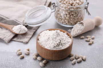 Fototapeta na wymiar Bean flour and seeds on light grey table