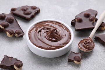 Sweet paste and chocolate pieces served on grey textured table, closeup