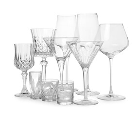 Different elegant empty glasses isolated on white