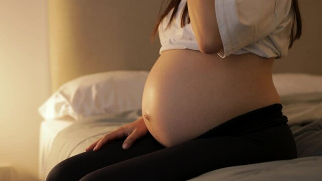 pregnant girl takes apple from bed, bed, belly pregnant