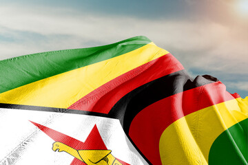 Zimbabwe national flag cloth fabric waving on beautiful grey sky. - obrazy, fototapety, plakaty