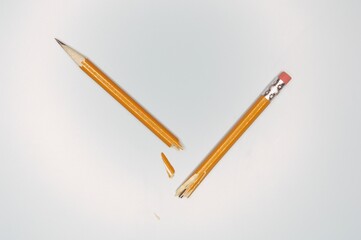 Close-up shot of a broken pencil on the white background