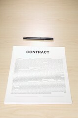 Vertical shot of a contract paper with a pen