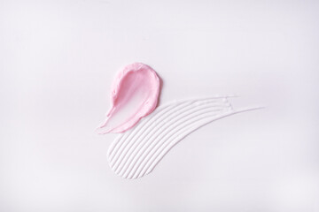 White and pink Creamy drops skincare cream product lotion on white background