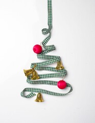 Vertical shot of a Christmas tree made of ribbons on a white background.