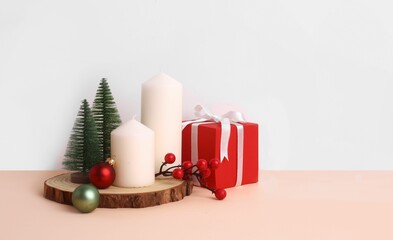 Christmas setup with colorful decorations against white wall with copyspace
