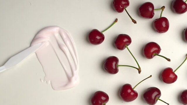 Lotion cream texture swatch with fresh cherries