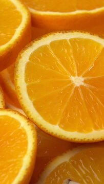 Vertical footage of juicy freshly sliced oranges