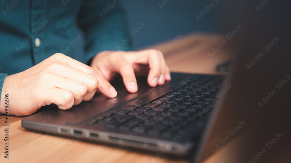 Poster Close-up shot of young man working and typing on laptop computer keyboard on wooden table in cafe. Chat with AI or artificial intelligence using an artificial intelligence chatbot developed.