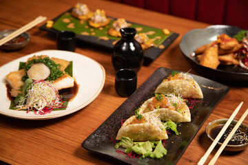 nikkei food dishes on a table with sake 