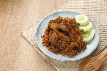 Ayam Goreng Lengkuas, fried chicken cooked with spices and sprinkled with grated galangal. Indonesian traditional food.  
