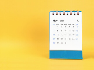 The May 2023 desk calendar on yellow color background. - obrazy, fototapety, plakaty