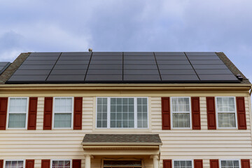 solar panels on the roof of new built houses collecting green energy from the sun in a modern and sustainable way
