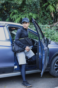 Sportsman Getting Out From Car Bring Sport Bag. 