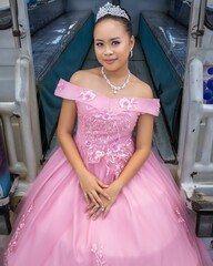 Philippine princess wearing a pink dress and a crown and looking at the camera