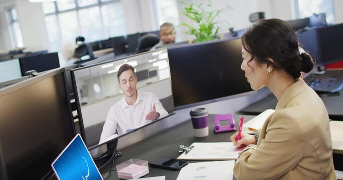 Diverse business people on computer video call with data processing on laptop in office