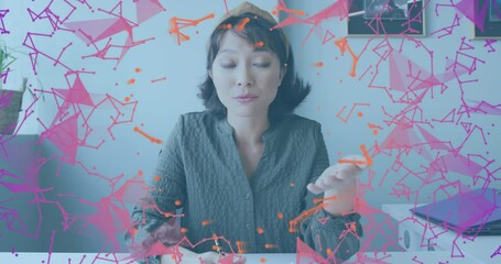 Animation of plexus networks against asian woman having a video call at office - Powered by Adobe
