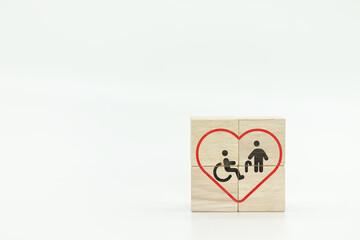Disability person and elderly icons in red heart  on wooden blocks , retirement living concept, care, nursing home 