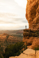 Woman looking out at dramatic sunset from Cathedral Rock.