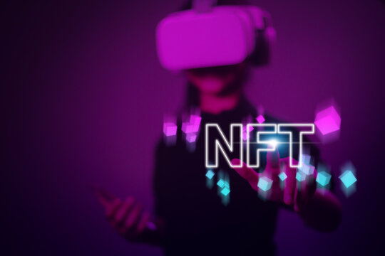 Women with virtual reality VR goggle finger touch virtual screen, NFT token digital crypto art blockchain technology concept - Powered by Adobe