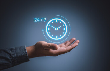 Best service mind concept. Businessman hand holding virtual analog clock with word 24/7 for...
