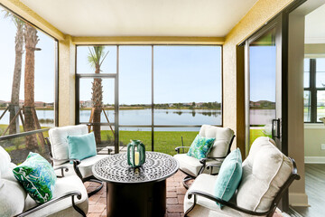 Patio with Luxury Furniture on a Clear Day and Clear Lake in the Background with Blue Sky in...