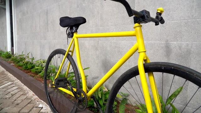 City bicycle fixed gear on grey wall. Cycling or commuting in city urban environment, ecological transportation concept.