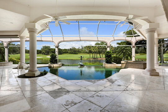 Luxury Lanai Pool with View of Golf Course in Gated Community in Naples, Florida Featuring Beautiful Landscaping
