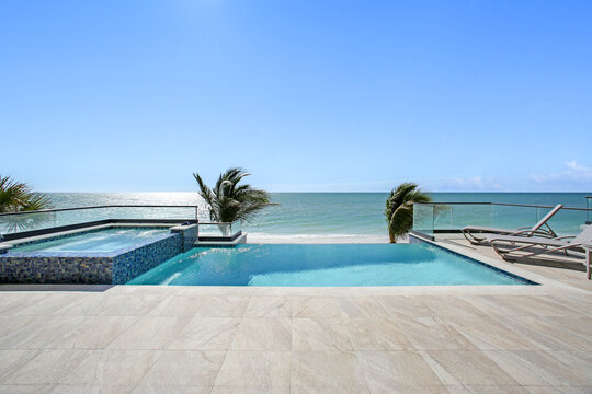 Beach View with Pool and Hot Tub Jacuzzi in the Foreground and Clear Skies with the Gulf of Mexico in the Background